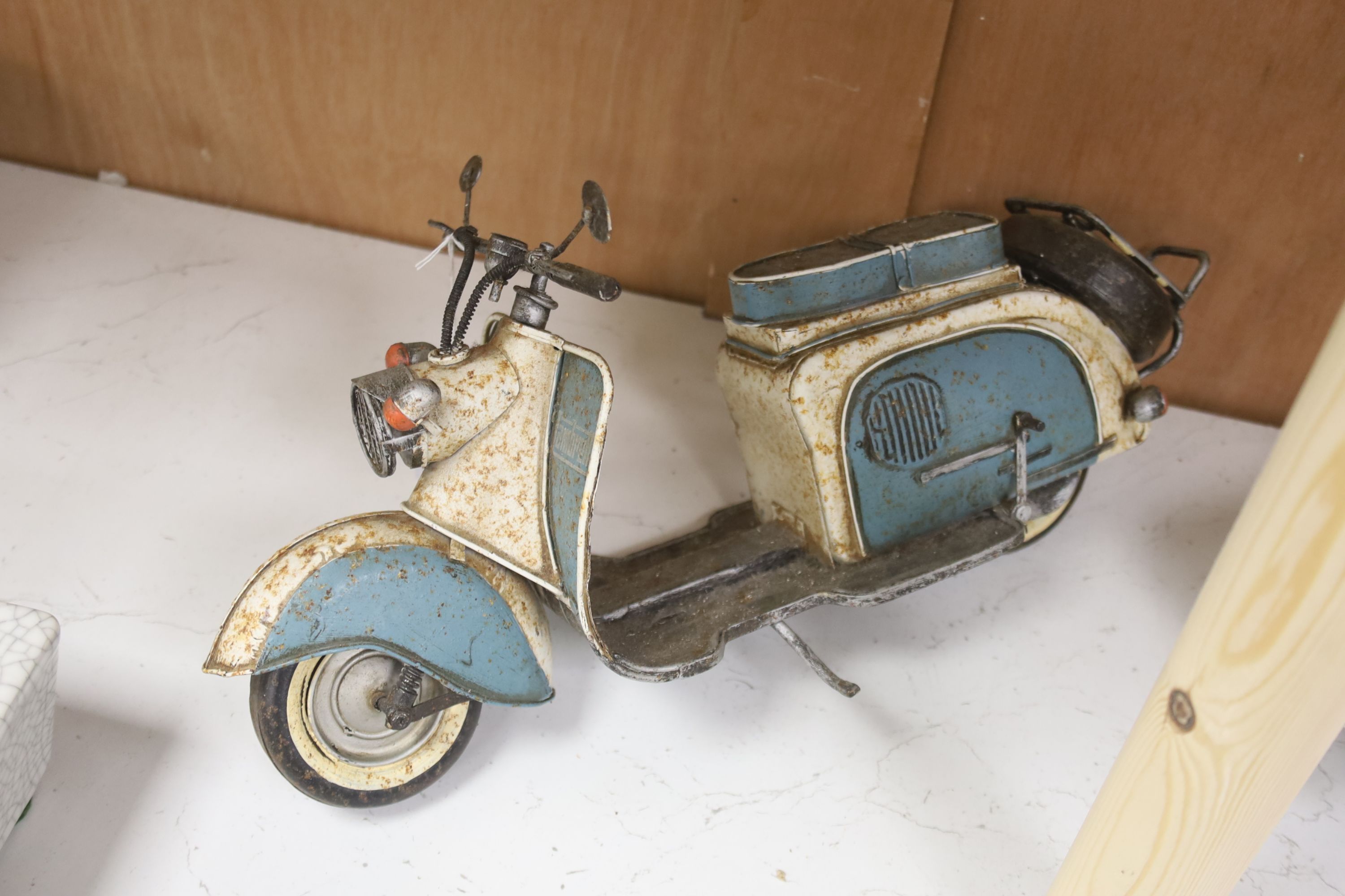 A model of a VW Camper van, a Lambretta and a 1950s Cadalac